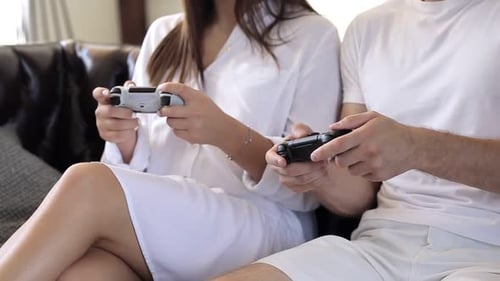 Young Couple Plays Video Games at Home