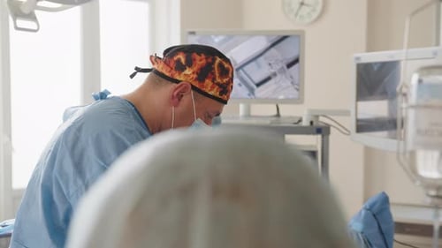 Medical Professionals Performing Surgery in Bright Operating Room