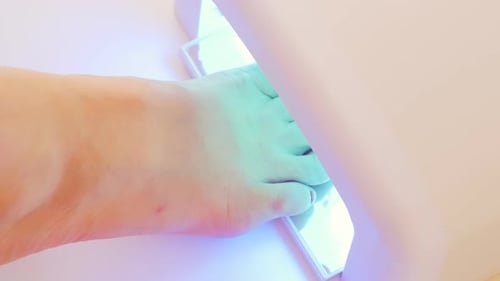 Foot Under Blue Light with Pink Nail Polish