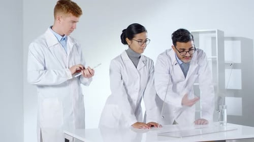 Three Scientists Working in Hi-tech Lab