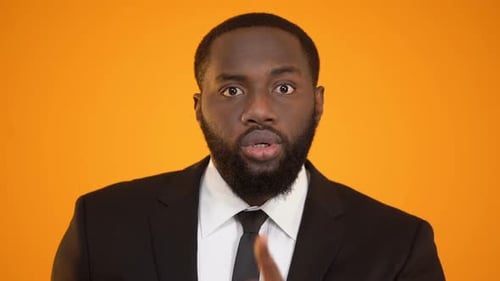 Man Smiling and Shushing with Finger