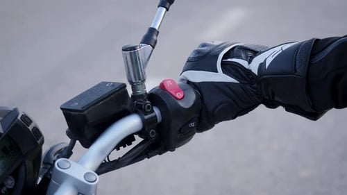 Hand Gripping Handle Bars of Motorcycle Close Up