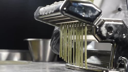 Chef Making Fresh Pasta with a Pasta Machine