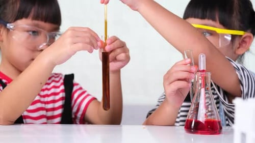 Kids Doing Science Experiments With Colorful Liquids