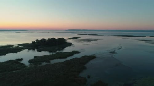 Aerial Drone Footage. Fly Over River with Islands at Sunrise
