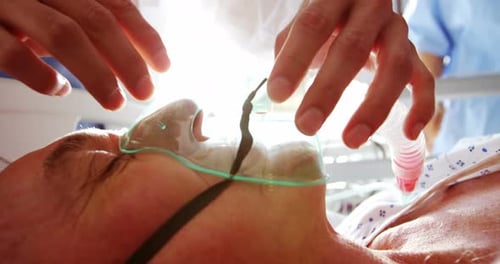 Senior Patient Receives Oxygen Mask in Hospital