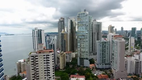 Aerial drone footage of buildings in Panama City in front of the sea