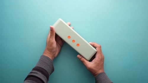 Man's Hand Using Smart Speaker on Table