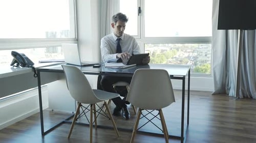 Businessman using digital tablet in office