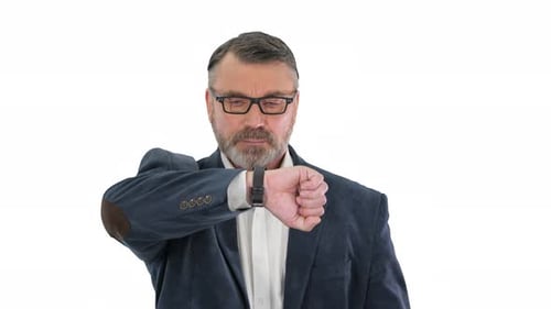 Successful Businessman Walking Fast Looking at Watch on White Background.