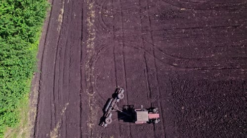 Tractor in the Dust Working in the Field