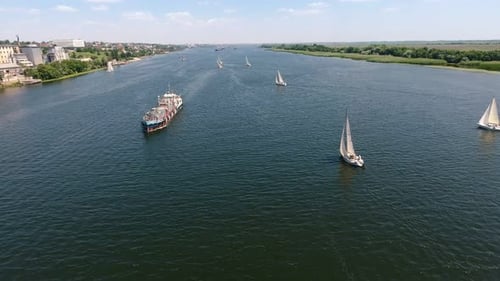 Aerial View of Sailboats on a Wide River