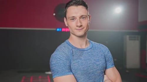 Confident Athletic Man Posing at the Gym