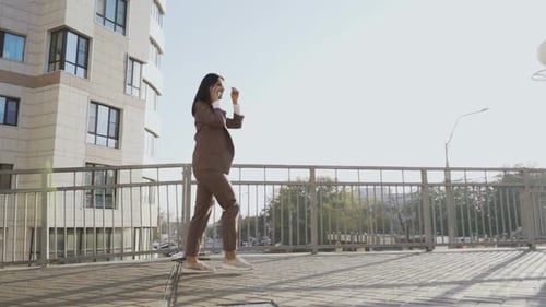 Beautiful Brunette Businesswoman In Business Clothes Walks In The City