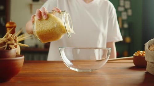 Person Preparing Rice in a Bowl at Home