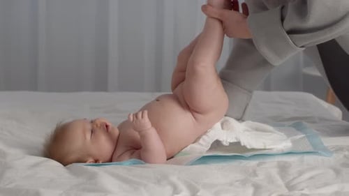 Infant Getting Diaper Changed on Changing Pad