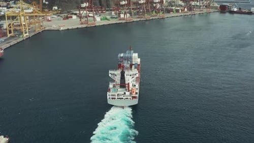 Cargo Ship with Sea Containers Comes in a Cargo Port Terminal