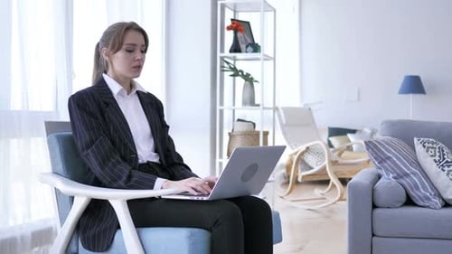 Young Adult Woman Works on Laptop, Reacts Surprised