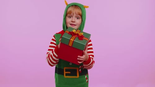Child Dressed as Elf Holds Christmas Gift
