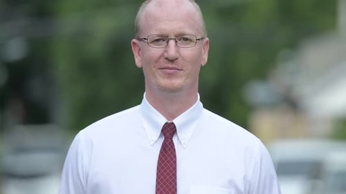 Man Smiling Close Up Wearing White Shirt and Tie