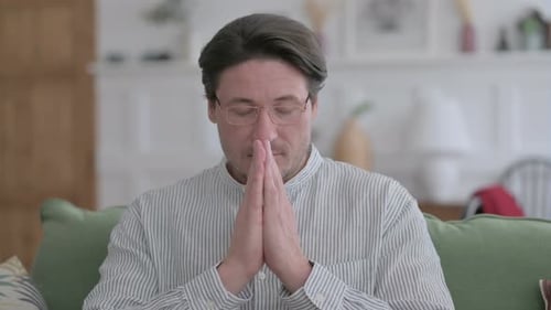 Porträt eines Mannes, der mit den Händen zusammen betet