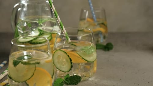 Refreshing Drink in Glasses with Fruit and Herbs
