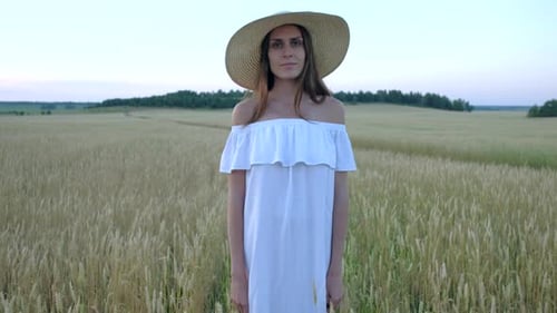 Amazing Portrait of Beautiful Woman Standing in Field of Ripe Golden Wheat