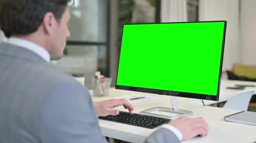 Businessman Using Desktop with Green Chroma Key Screen