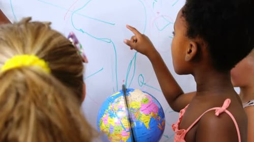 Children Learning Geography Around White Board and Globe