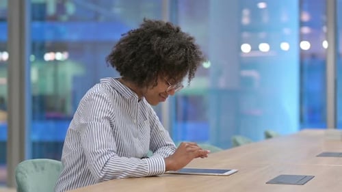 Young African Businesswoman Using Tablet in Office