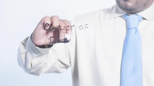 Writing Conflict of Interest on Clear Surface
