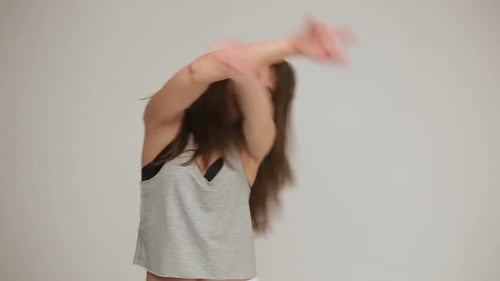 Attractive Young Woman Dancing with Energy and Enthusiasm