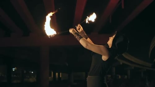 Woman Performs With Fire at Night