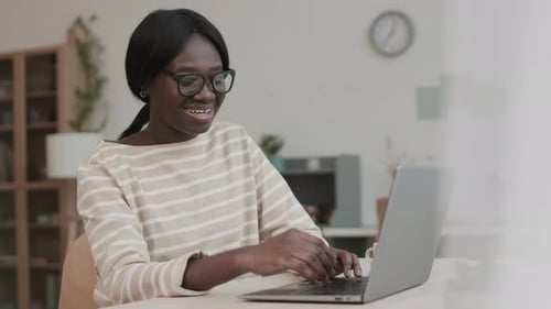 Woman Using Laptop for Video Conference at Home