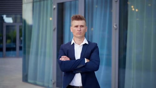 Confident Man Smiling in Front of Office Building