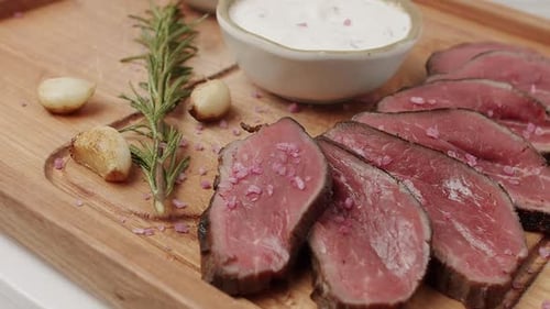 Sliced Beef Tenderloin with Creamy Sauce and Rosemary