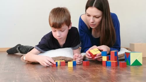 Woman and Boy Playing with Blocks at Home
