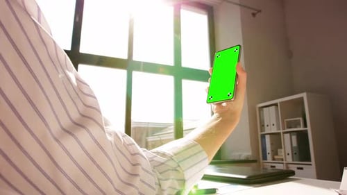 Hand with Green Screen on Phone at Home Office