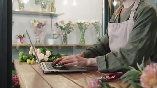 Woman Working on Laptop in Flower Shop