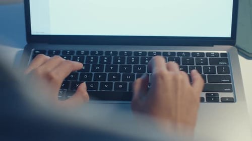 Hands Typing on Silver Laptop Computer Keyboard