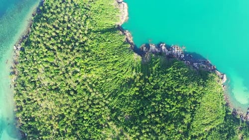Beautiful flying tourism shot of a sandy white paradise beach and aqua turquoise water background in