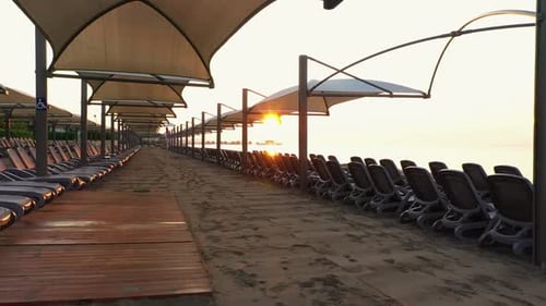 Beach Loungers and Umbrellas on an Empty Beach in the Evening.
