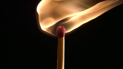 Matchstick Flame Burns Brightly in the Darkness