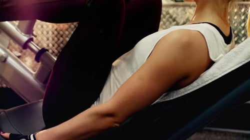 Woman Using Leg Press at the Gym