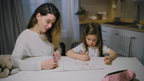 Woman and Child Drawing Together Indoors