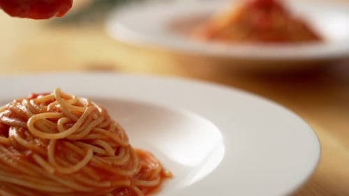 Red Sauce Poured Over Spaghetti on White Plate