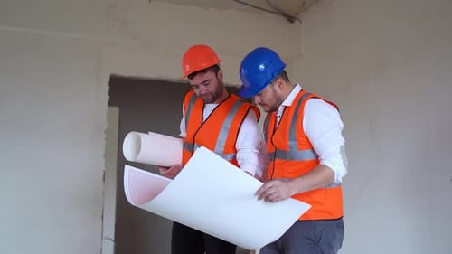 Architects and Construction Workers Reviewing Blueprints