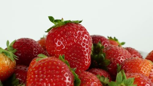 Rotation 360 berry strawberry on a white background. Juicy summer strawberry close-up