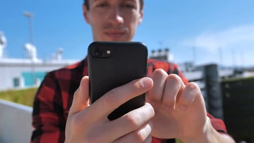 Young Adult Using Smartphone Outdoors