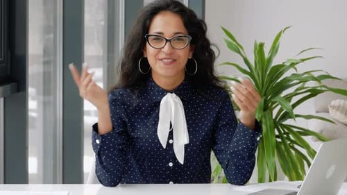 Webcam view. Mixed race businesswoman talking to camera making conference business call. Teacher or